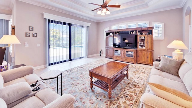 living area with plenty of natural light, ornamental molding, ceiling fan, and tile patterned floors