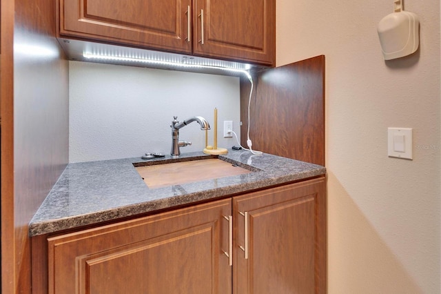 kitchen featuring brown cabinets and a sink