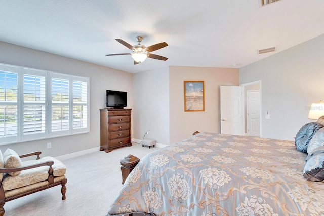 carpeted bedroom with a ceiling fan, visible vents, and baseboards