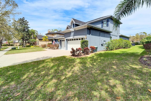 view of front of property with concrete driveway, a front lawn, an attached garage, and stucco siding