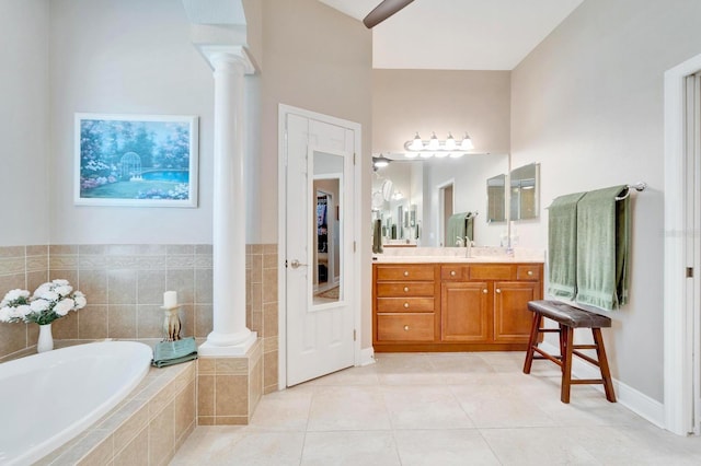 full bath featuring vanity, tile patterned flooring, a bath, and ornate columns