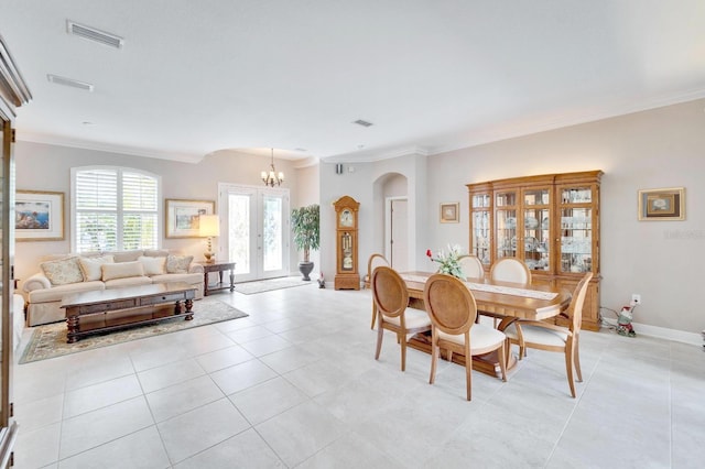 dining room with arched walkways, ornamental molding, light tile patterned flooring, and visible vents