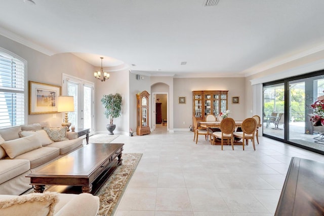 living area featuring a notable chandelier, baseboards, crown molding, and light tile patterned flooring