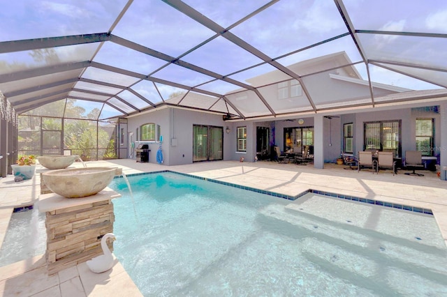 pool with glass enclosure and a patio area