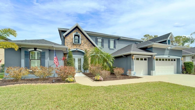 view of front of home featuring french doors, stucco siding, an attached garage, stone siding, and driveway