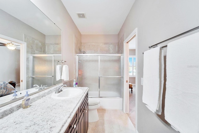 5115 Abisher Wood Ln, Brandon, FL 33511 - ensuite bathroom with vanity, toilet, shower / bath combination with glass door, tile patterned flooring, and a ceiling fan