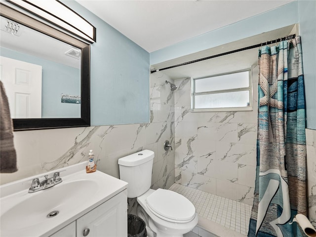 full bath featuring a stall shower, vanity, toilet, and tile walls