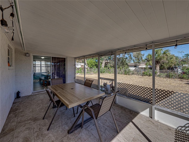 view of patio with outdoor dining space and fence