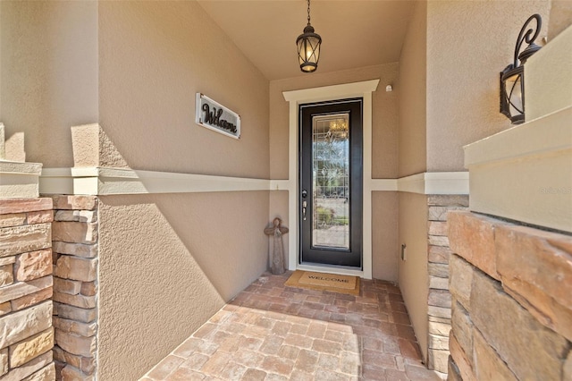 doorway to property with stucco siding