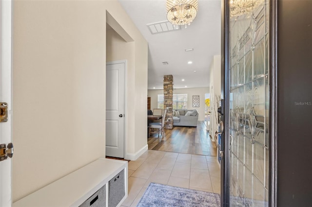 entryway with visible vents, recessed lighting, light tile patterned floors, baseboards, and a chandelier