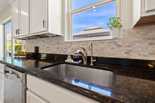 kitchen with dishwasher, a sink, a wealth of natural light, and white cabinets