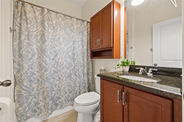 bathroom featuring tile patterned flooring, vanity, and toilet