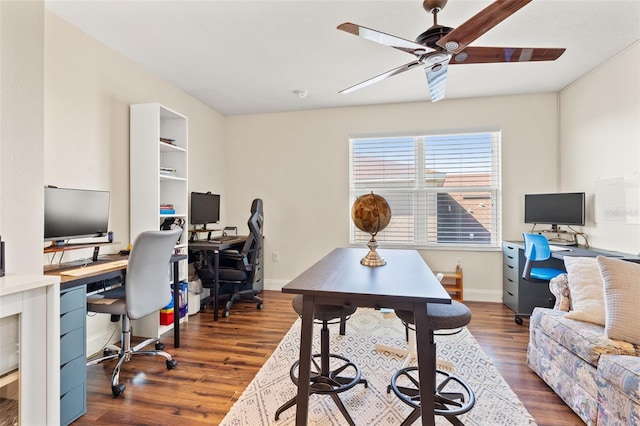 office area with baseboards, a ceiling fan, and wood finished floors