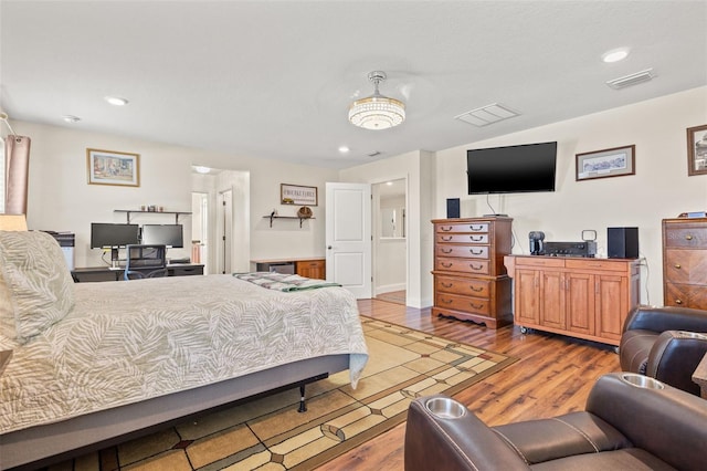 bedroom featuring light wood finished floors, visible vents, and recessed lighting