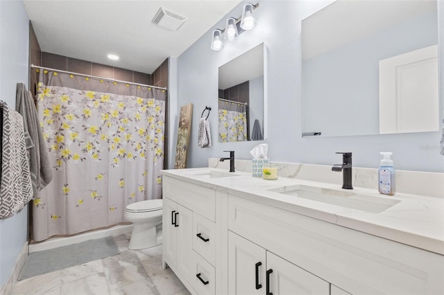 bathroom with toilet, marble finish floor, a sink, and visible vents