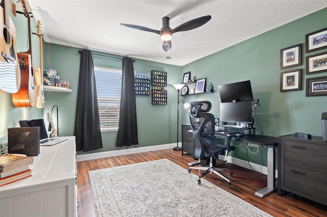 office with a textured ceiling, baseboards, and wood finished floors