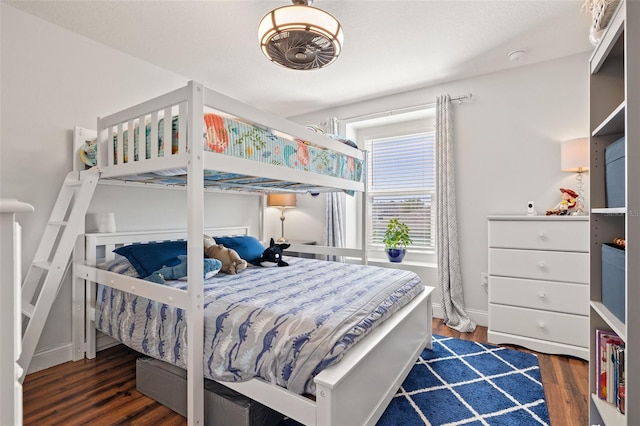 bedroom with baseboards and wood finished floors