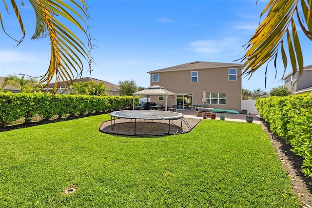 back of house with a gazebo, a yard, a patio, and stucco siding