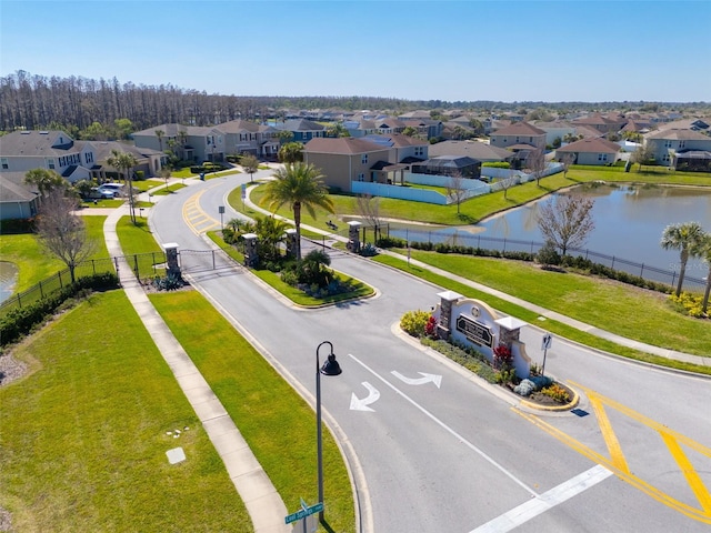 birds eye view of property featuring a water view and a residential view