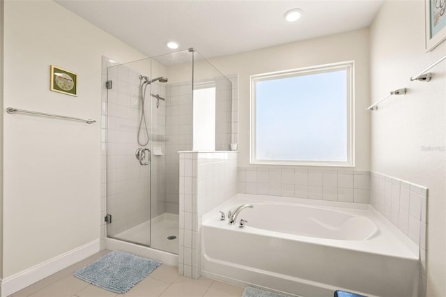 bathroom featuring baseboards, a garden tub, tile patterned flooring, a shower stall, and recessed lighting