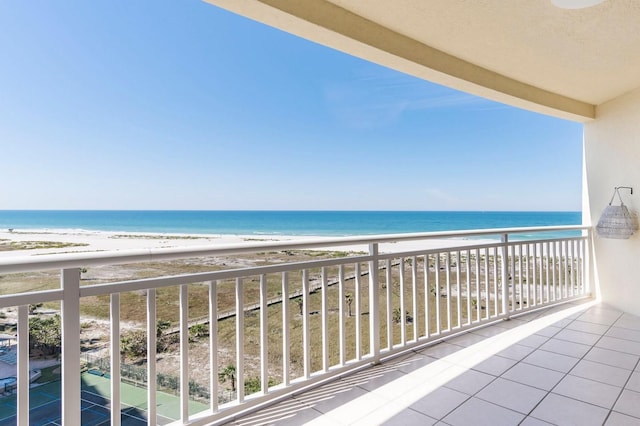 balcony featuring a water view and a beach view