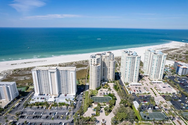 birds eye view of property with a water view, a beach view, and a city view