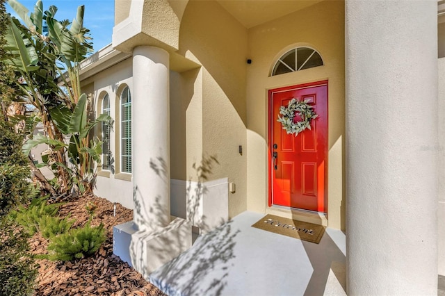 property entrance with stucco siding