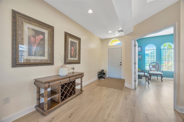 foyer featuring recessed lighting, visible vents, baseboards, and light wood-style floors