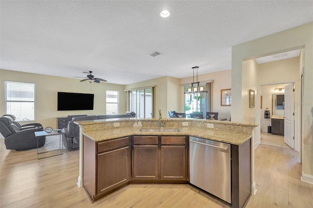 kitchen with a sink, visible vents, light wood-type flooring, and dishwasher