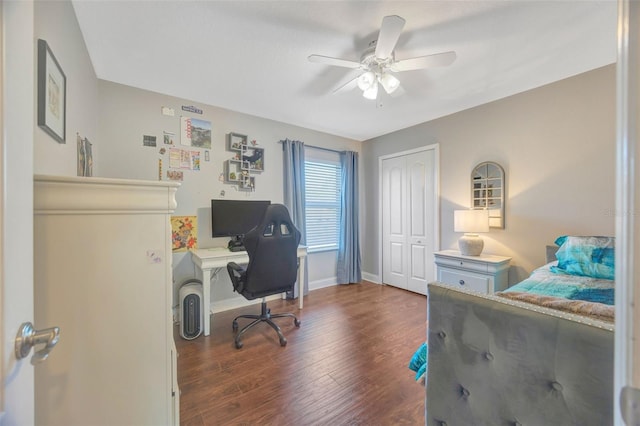 bedroom featuring a closet, a ceiling fan, dark wood-type flooring, and baseboards