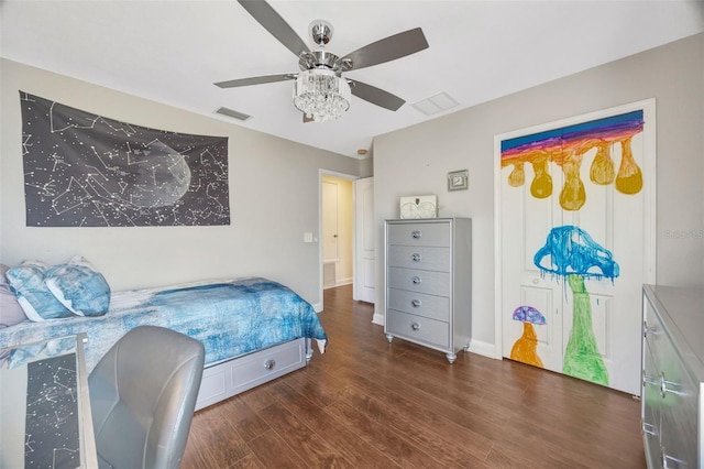 bedroom with visible vents, baseboards, ceiling fan, and wood finished floors