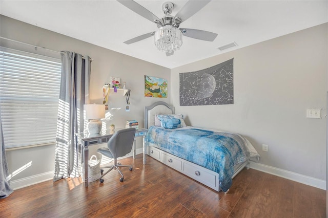 bedroom featuring visible vents, ceiling fan, baseboards, and wood finished floors