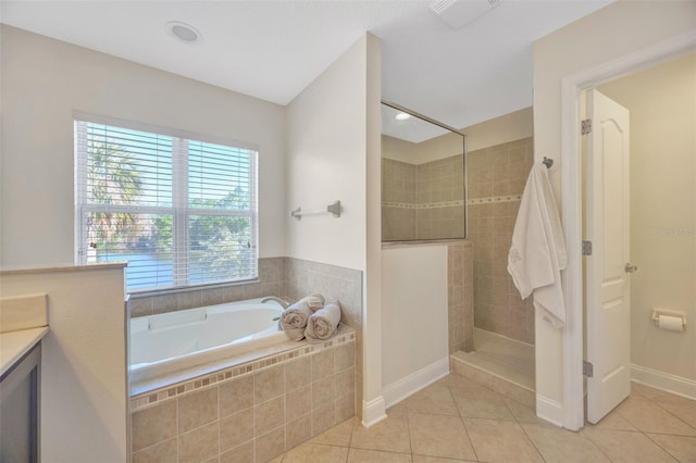 full bathroom featuring tile patterned floors, visible vents, a garden tub, and walk in shower