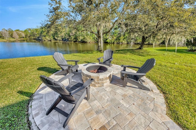 view of patio / terrace with an outdoor fire pit and a water view