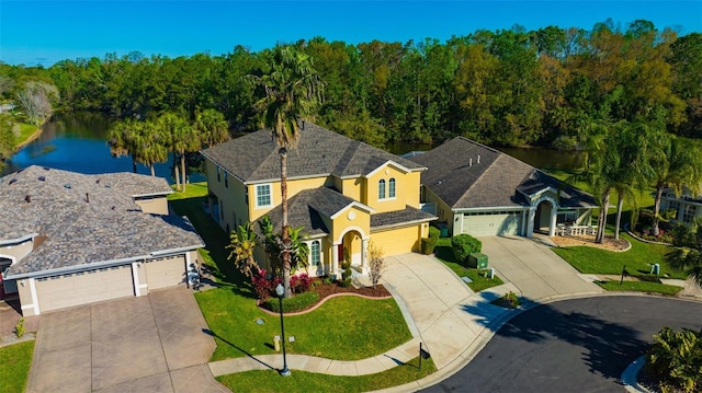 view of front of home with stucco siding, a front lawn, concrete driveway, and an attached garage