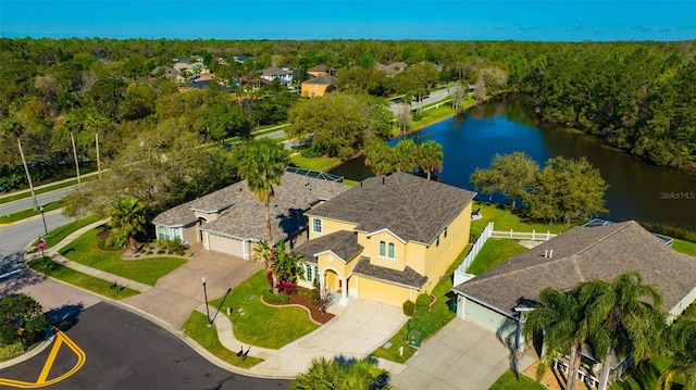 bird's eye view with a wooded view and a water view