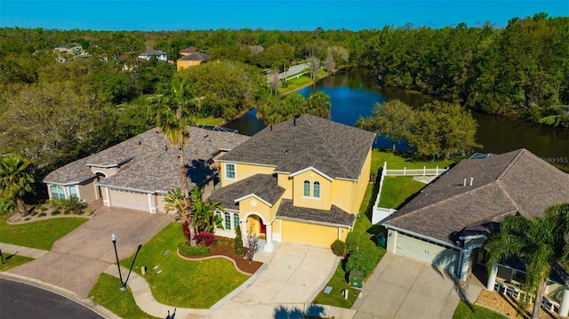 drone / aerial view featuring a water view and a wooded view