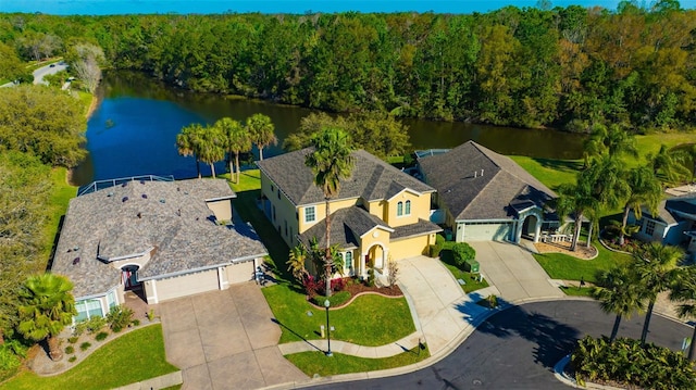 drone / aerial view featuring a view of trees and a water view