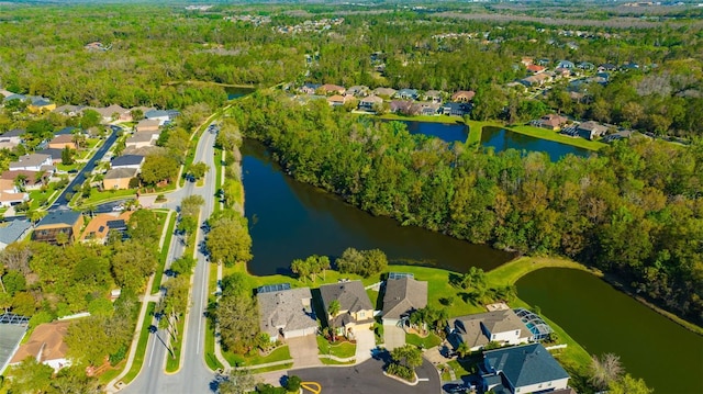 drone / aerial view featuring a residential view and a water view