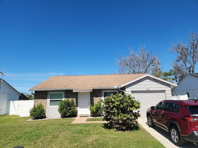 single story home featuring concrete driveway, fence, a garage, stone siding, and a front lawn