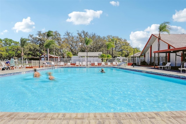 pool featuring a patio area and fence