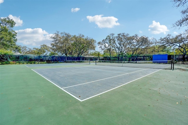 view of sport court featuring fence