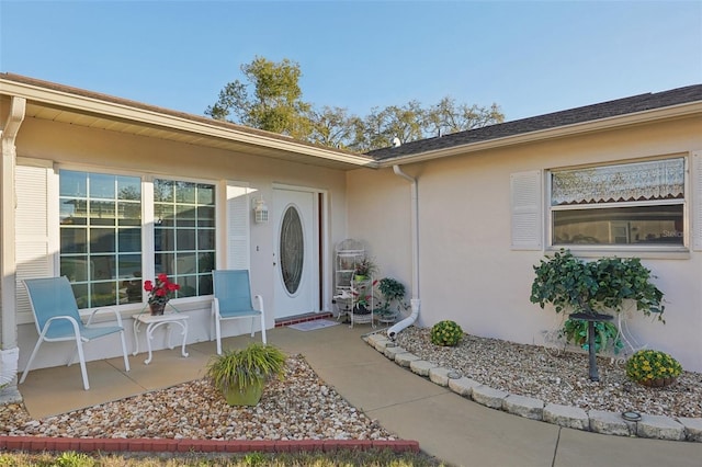 property entrance with stucco siding