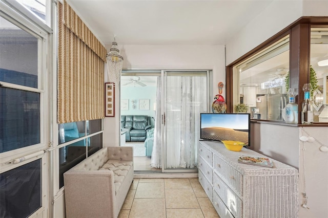 sitting room with ceiling fan and tile patterned floors