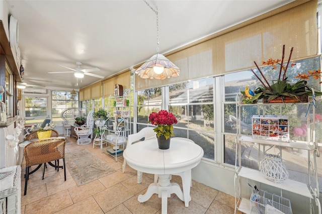 sunroom with an AC wall unit and a ceiling fan