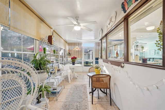 sunroom / solarium featuring a ceiling fan