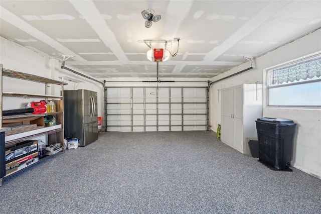 garage with a garage door opener and freestanding refrigerator