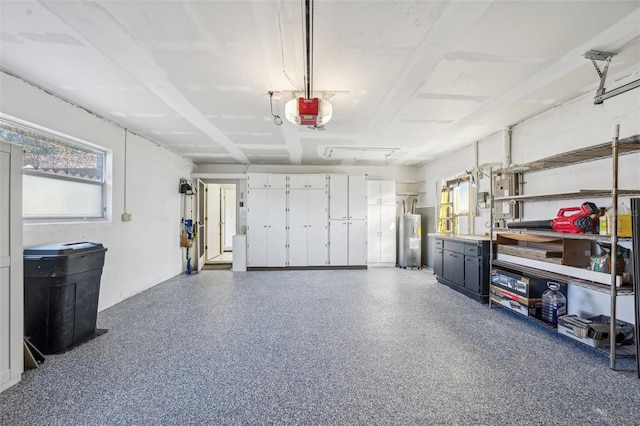 garage with electric water heater and a garage door opener