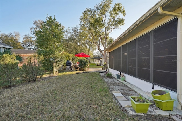 view of yard featuring a sunroom