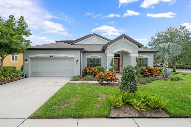 view of front of home with a garage, a front yard, and stucco siding